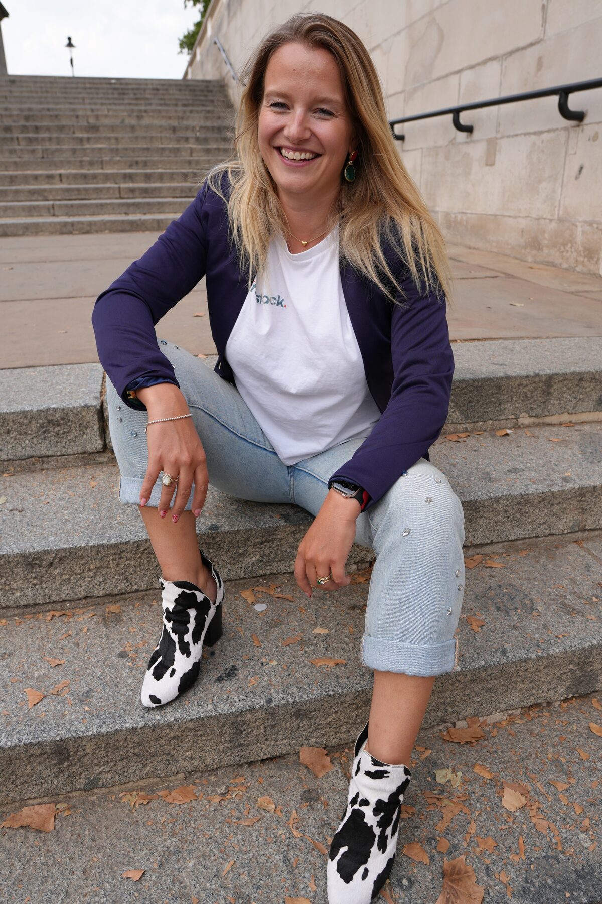 Claire Alvis, co-founder of lifestack, laughing on stone steps